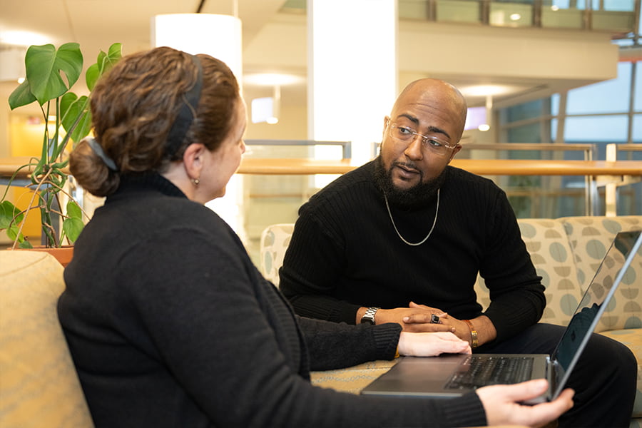 Staff talk in lounge in Integrated Sciences Complex.